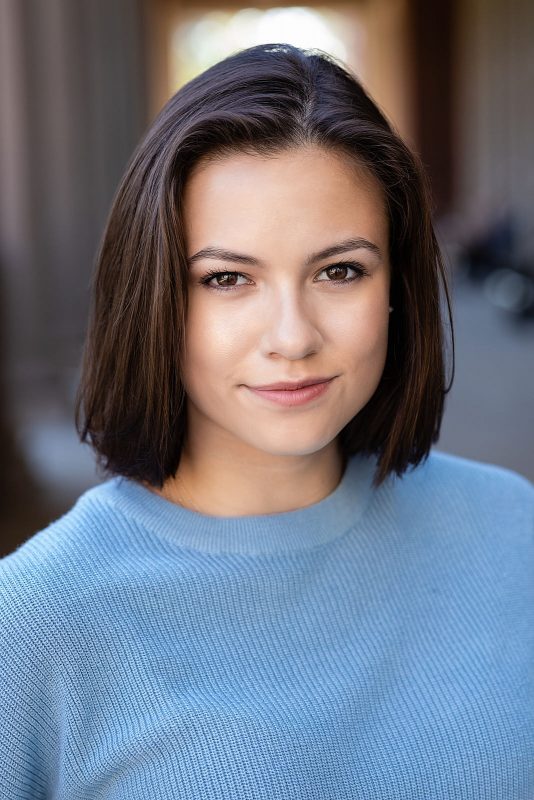 A close up of a person wearing a sweater